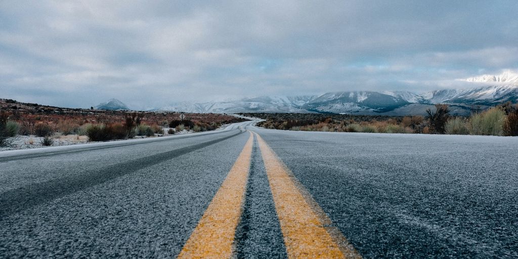 landscape photography of asphalt road under cloudy sky during daytime